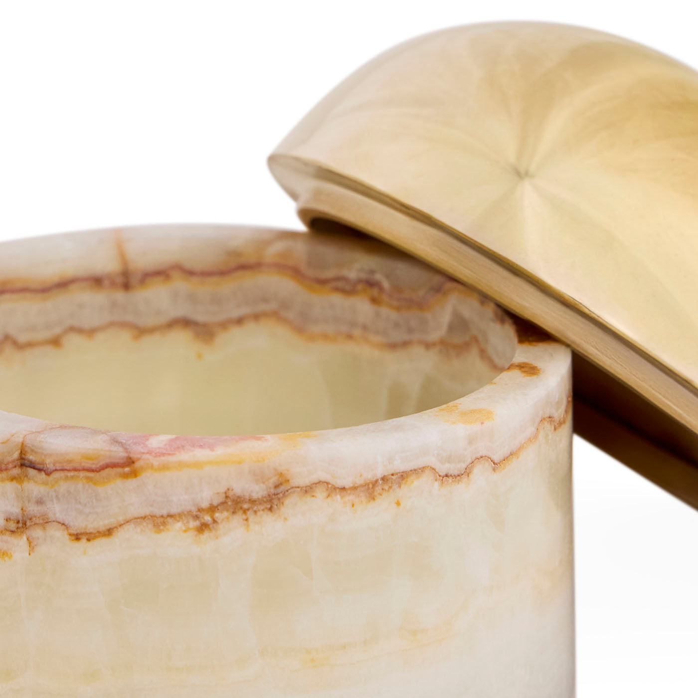 Marble-textured container with a gold lid on a white background