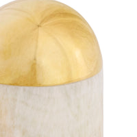 Decorative item with gold top and white base on a white background