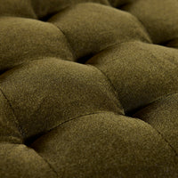Close-up of a green textured fabric with tufted design
