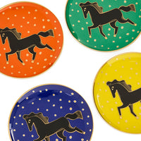 Four plates with black horse illustrations on polka dot backgrounds in orange, green, blue, and yellow.
