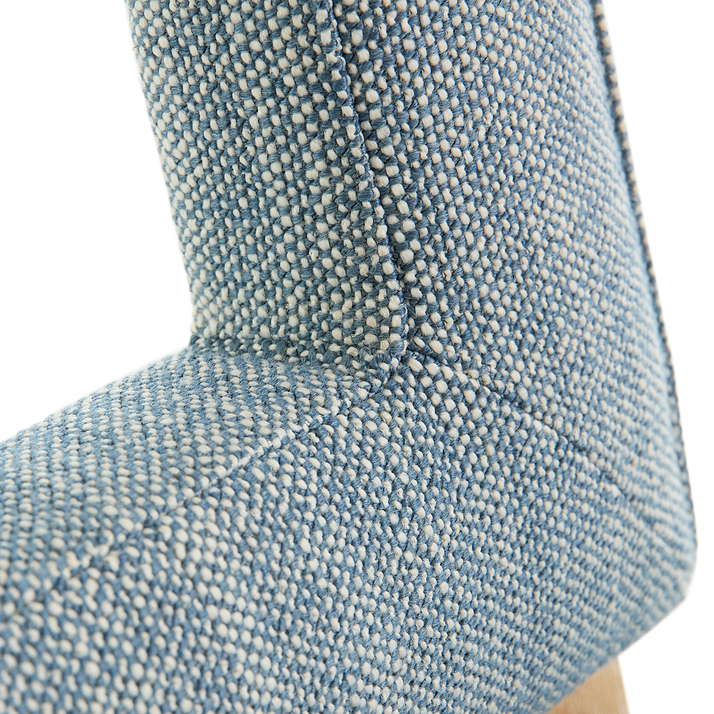 Close-up of a textured blue cushion on a white background