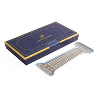 Jonathan Adler American Gothic Hand Lettered Iron Paper and Acrylic Combo Set, featuring a navy blue and gold presentation box alongside a matching metallic silver and gold lettered acrylic piece on a white background.