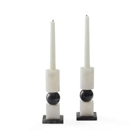set of two black and white candle stick holders styled with white candlesticks (not included) 