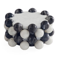 A round coffee table with a white marble top and a lower tier of alternating smooth white and dark gray/black marble spheres, shown on a white background.