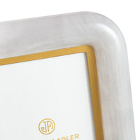 Close-up of a white electronic device with a gold border and logo on a white background