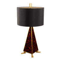 Table lamp with black shade and tortoiseshell base on a white background