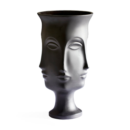 A sculptural black ceramic vase shaped like a stylized female face, photographed against a solid white background.