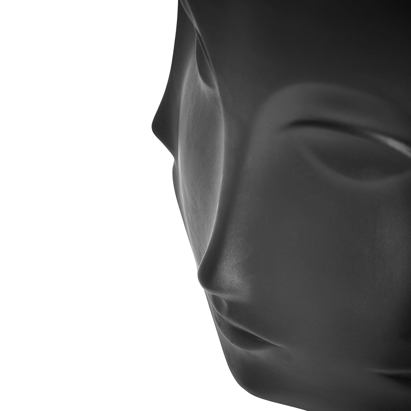 Close-up side profile of a matte black decorative head sculpture on a plain white background.