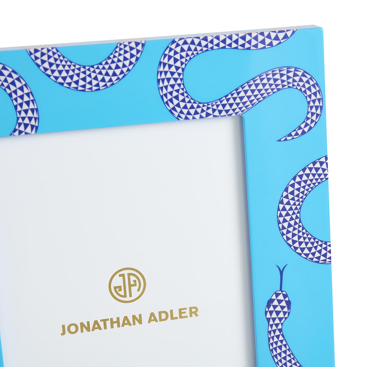 Product packaging with snake pattern and 'Jonathan Adler' branding on a blue background