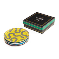 Stack of yellow patterned coasters with a black box labeled 'Eden' on a white background