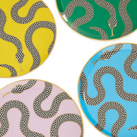 Four decorative plates with snake patterns on yellow, green, pink, and blue backgrounds.