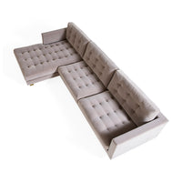 Gray tufted sectional sofa on a white background
