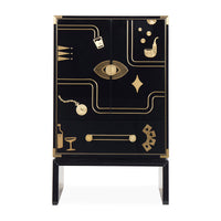A black and gold two-door cabinet with decorative gold illustrations of everyday objects and geometric patterns, set against a plain white background.