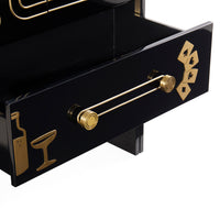 A close-up of a glossy black drawer with a gold bar-themed handle and gold decorative icons on the front, set against a clean white background.