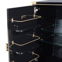 Close-up of the open interior of a black display cabinet or cabinet door, showing three black shelves with gold metal wire racks and glass shelves inside.