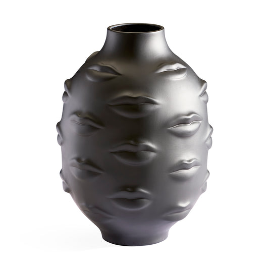 A dark gray matte ceramic vase featuring a sculptural design of embossed lips on its surface, set against a plain white background.