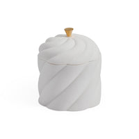 A white ceramic jar with a matching lid featuring a sculpted, twisted swirl design and a small gold-toned knob on top, set against a plain white background.