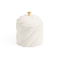 A white ceramic lidded container with a sculpted, twisted spiral design and a small gold-toned knob on top, set against a plain white background.