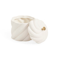 A white ceramic container with a matching lid, featuring a sculpted spiral design and a small gold knob on the lid, set against a plain white background.