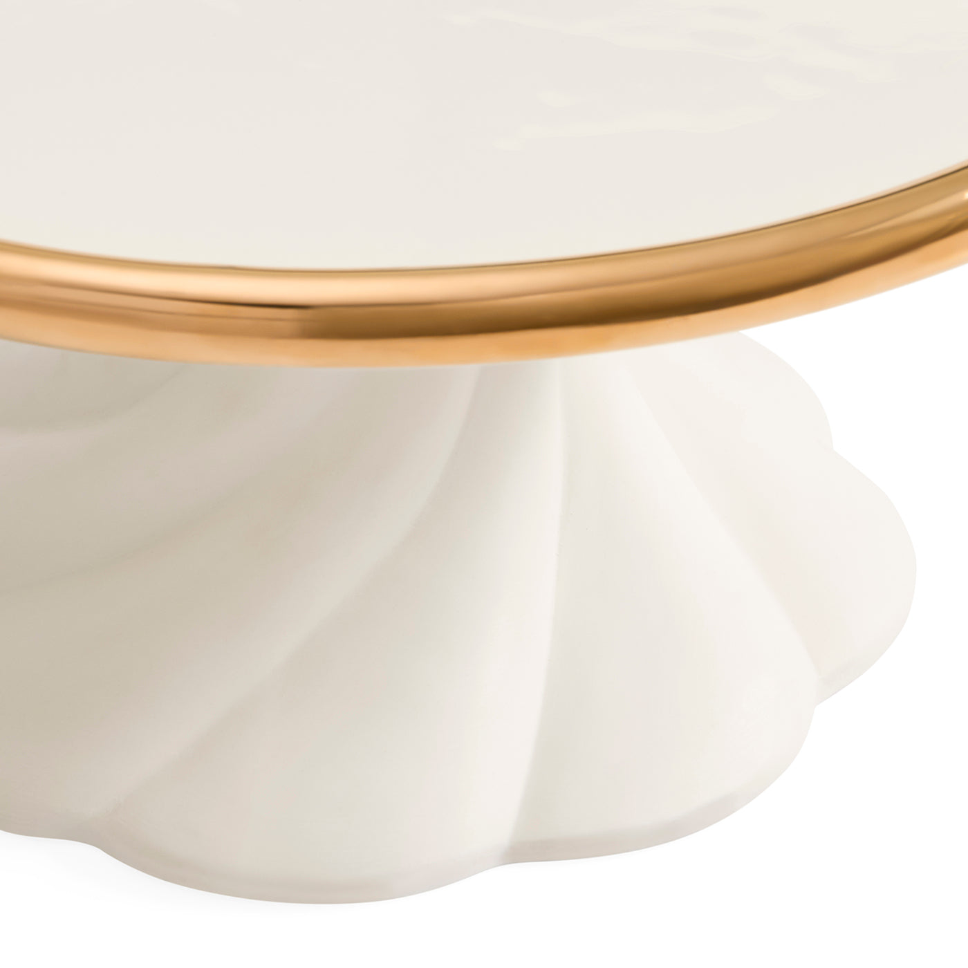 Close-up of a white pedestal table base with a fluted scalloped edge and a polished gold metal rim, shown against a white background.