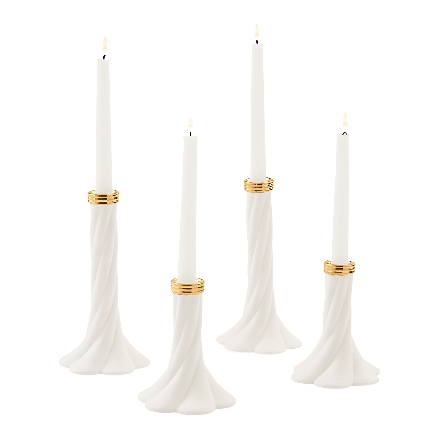 Four white taper candles in sculpted white holders with gold bands, shown on a plain white background.