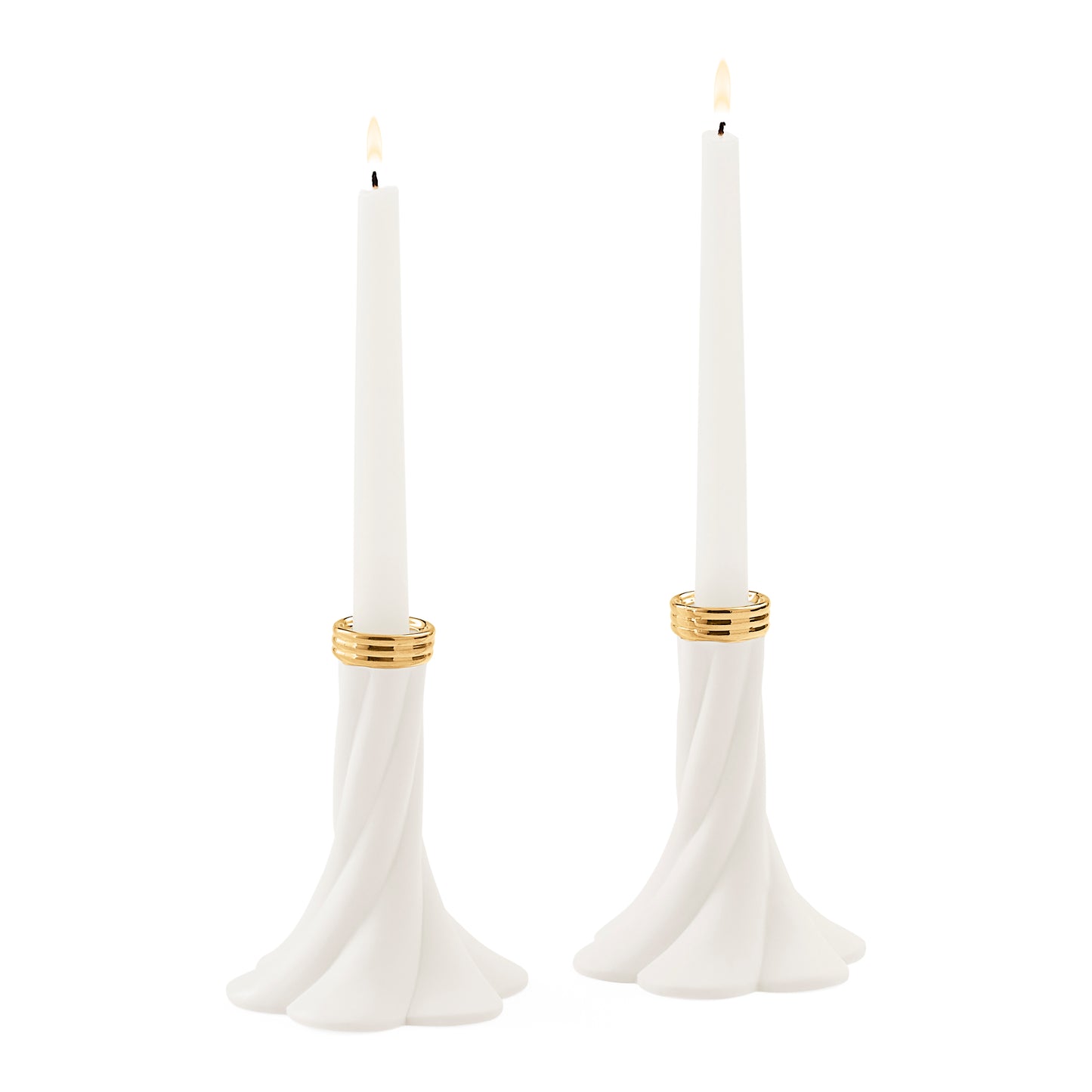 Two white taper candles in sculptural flared holders with gold bands, shown on a plain white background.