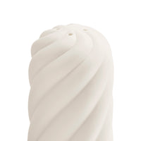A close-up of a white spiral-textured object, likely a decorative sculpture or modern vase, on a solid white background.