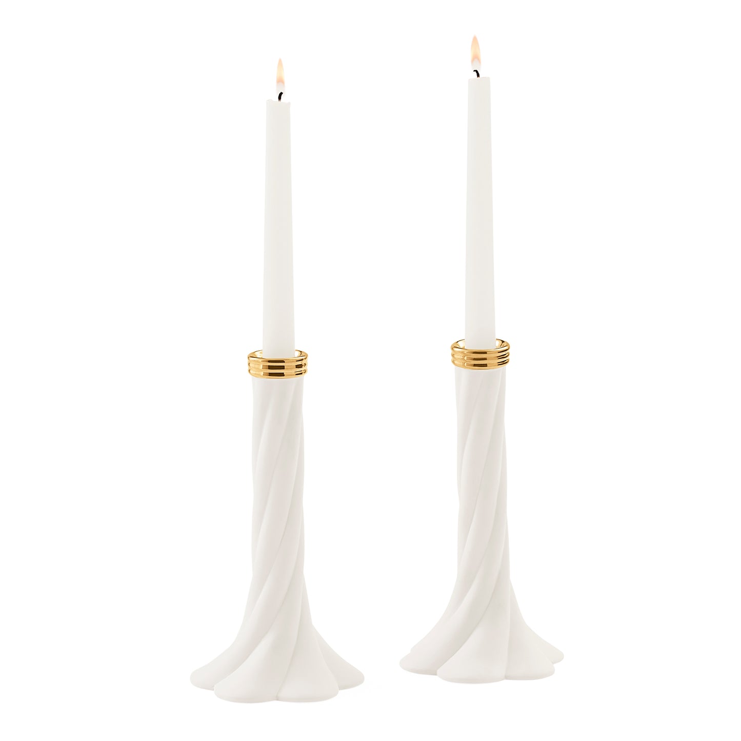 A pair of white taper candle holders with a twisted base and gold metallic bands, each holding a white taper candle with a lit flame, set against a solid white background.