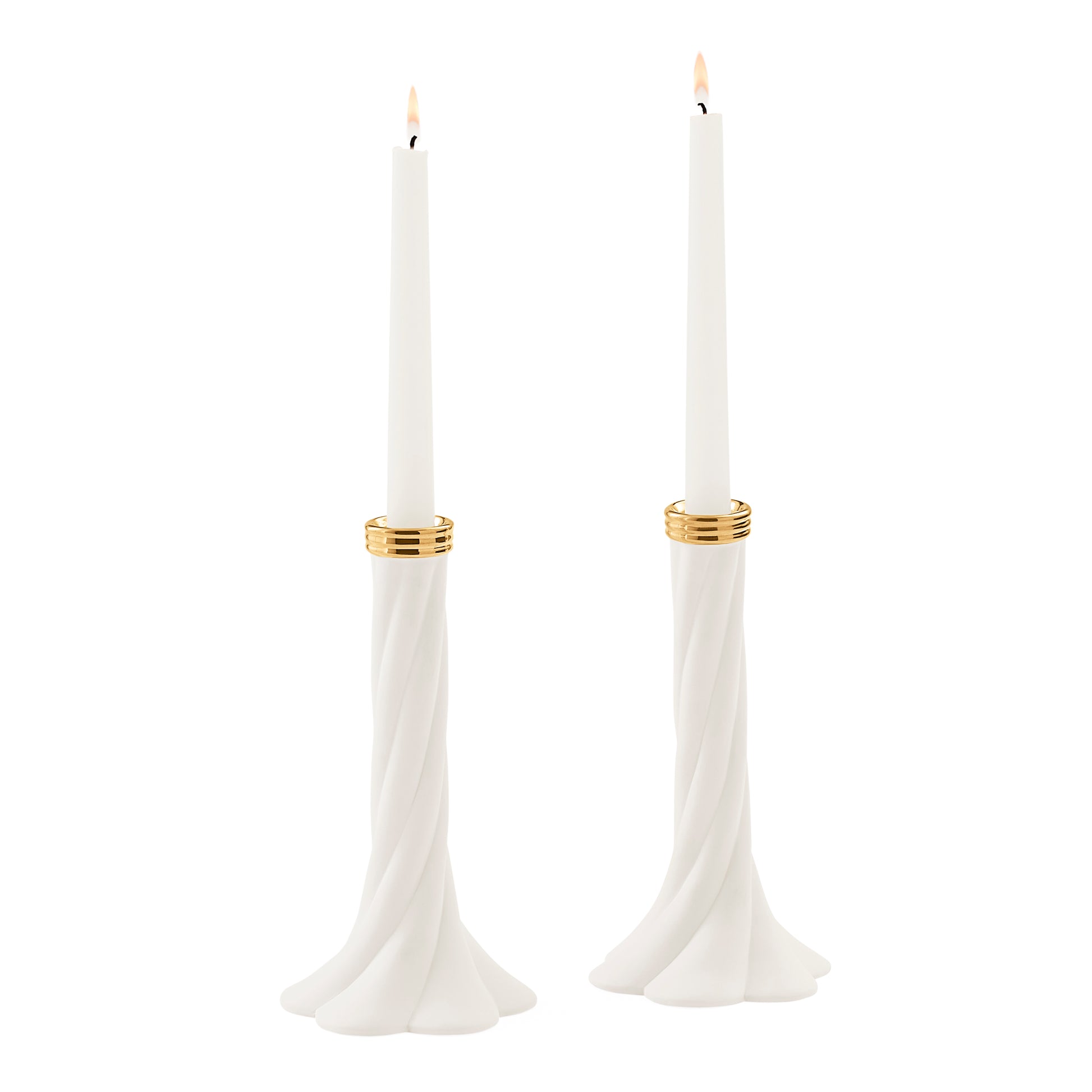 A pair of white taper candle holders with a twisted base and gold metallic bands, each holding a white taper candle with a lit flame, set against a solid white background.