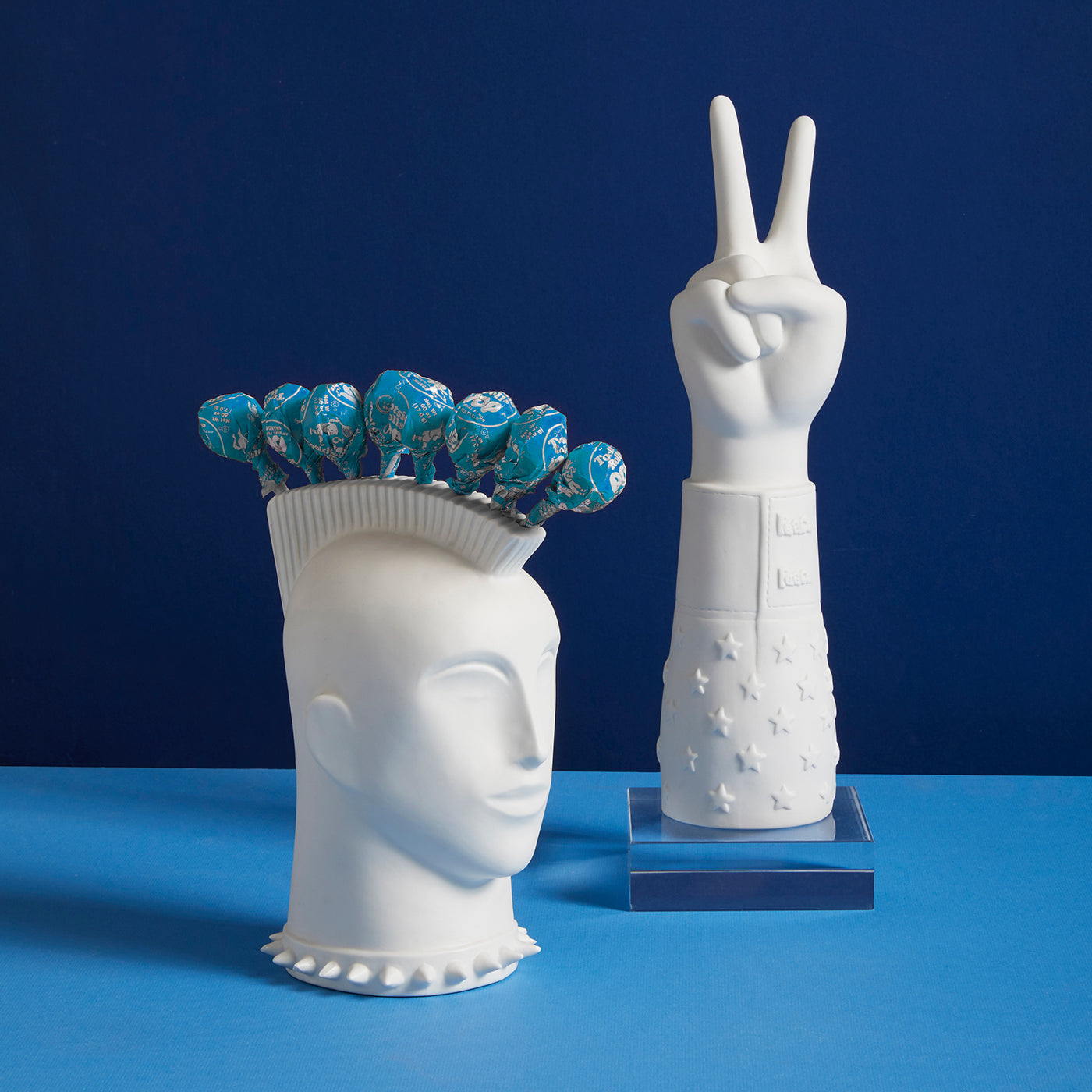 mohawk lollipop holder peace hand blue background - styled view