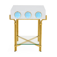 Decorative side table with gold frame, white top, and blue circular accents on a white background