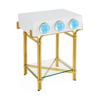 Decorative side table with gold frame, white top, and glass shelf on a white background
