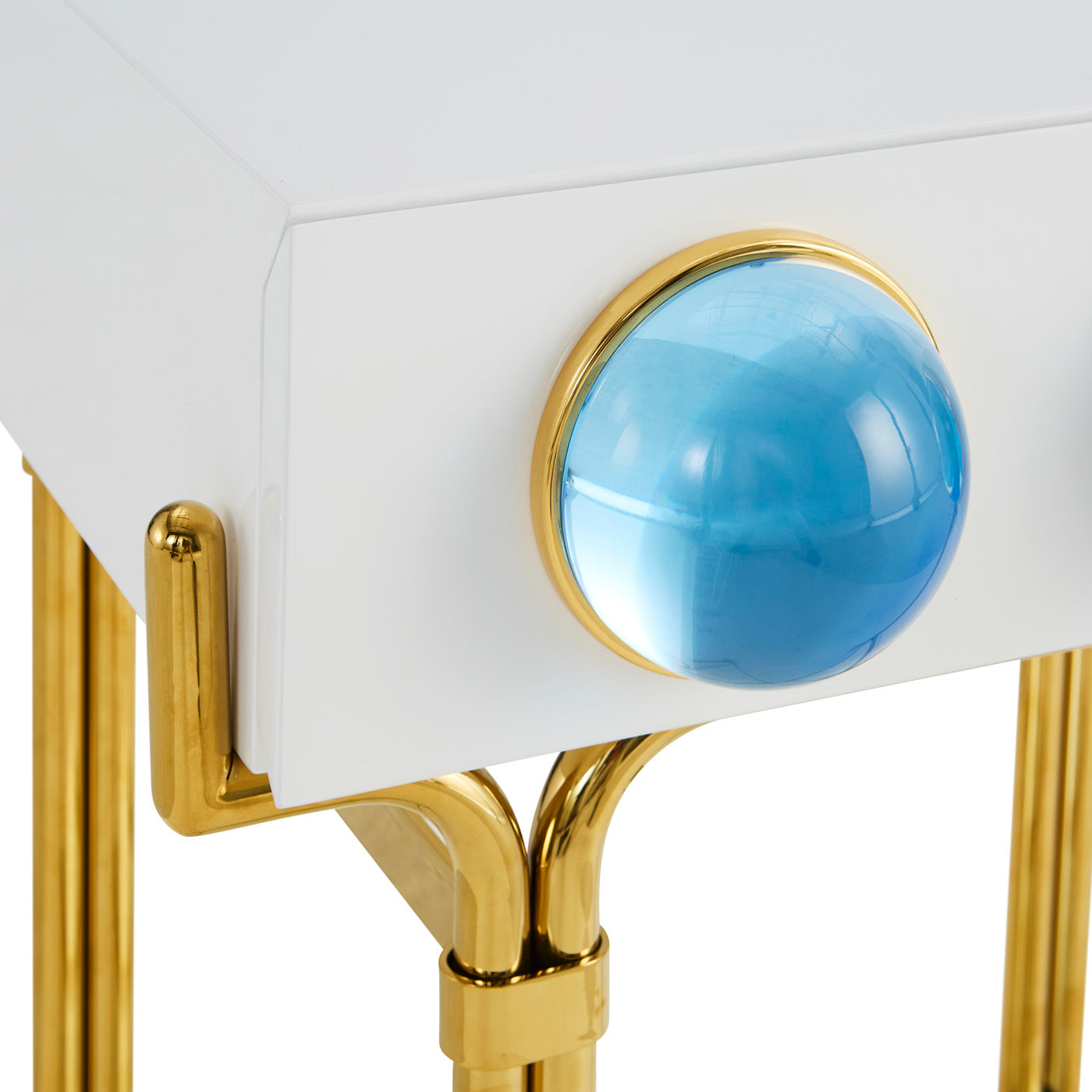 Decorative object with blue sphere and gold accents on a white background