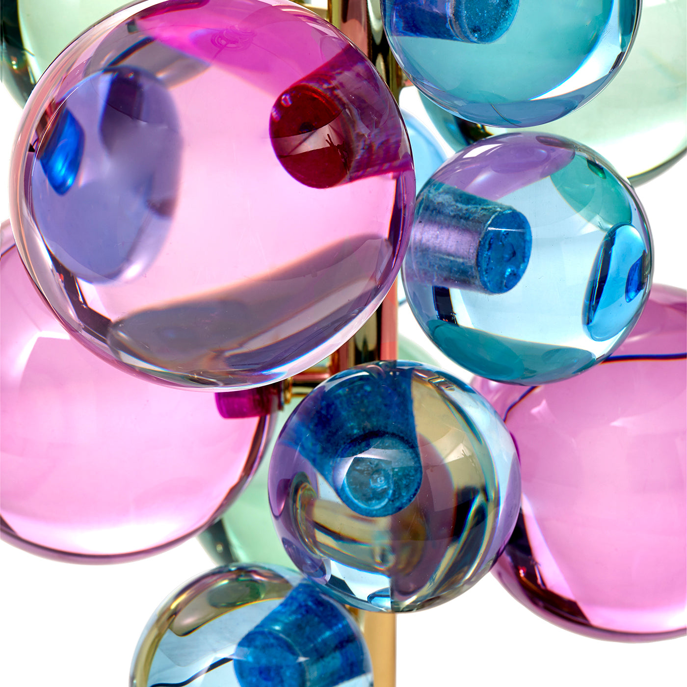 Close-up of colorful glass spheres on a reflective surface