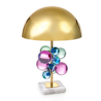 Table lamp with gold shade and colorful glass balls on a white background