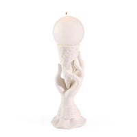White candle holder with a spherical candle on a white background