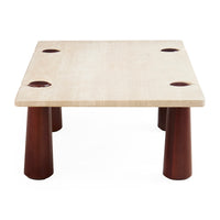 A low square table with a light beige stone top featuring four circular cutouts and four dark reddish-brown tapered legs, shown on a plain white background.