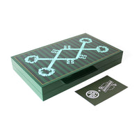 A dark green rectangular presentation box with a glossy finish, featuring a mint green key graphic and circular floral motifs on top. A small matching dark green card with a white logo sits in front on a clean white background.