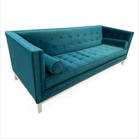 Teal sofa with tufted backrest on a white background