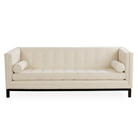 An off-white upholstered loveseat with tufted backrest, cylindrical bolsters, and a black metal frame, shown against a plain white background.