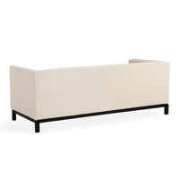 A modern rectangular sofa or chaise lounge with cream textured upholstery and a black metal frame, shown from a three-quarters angle on a white background.