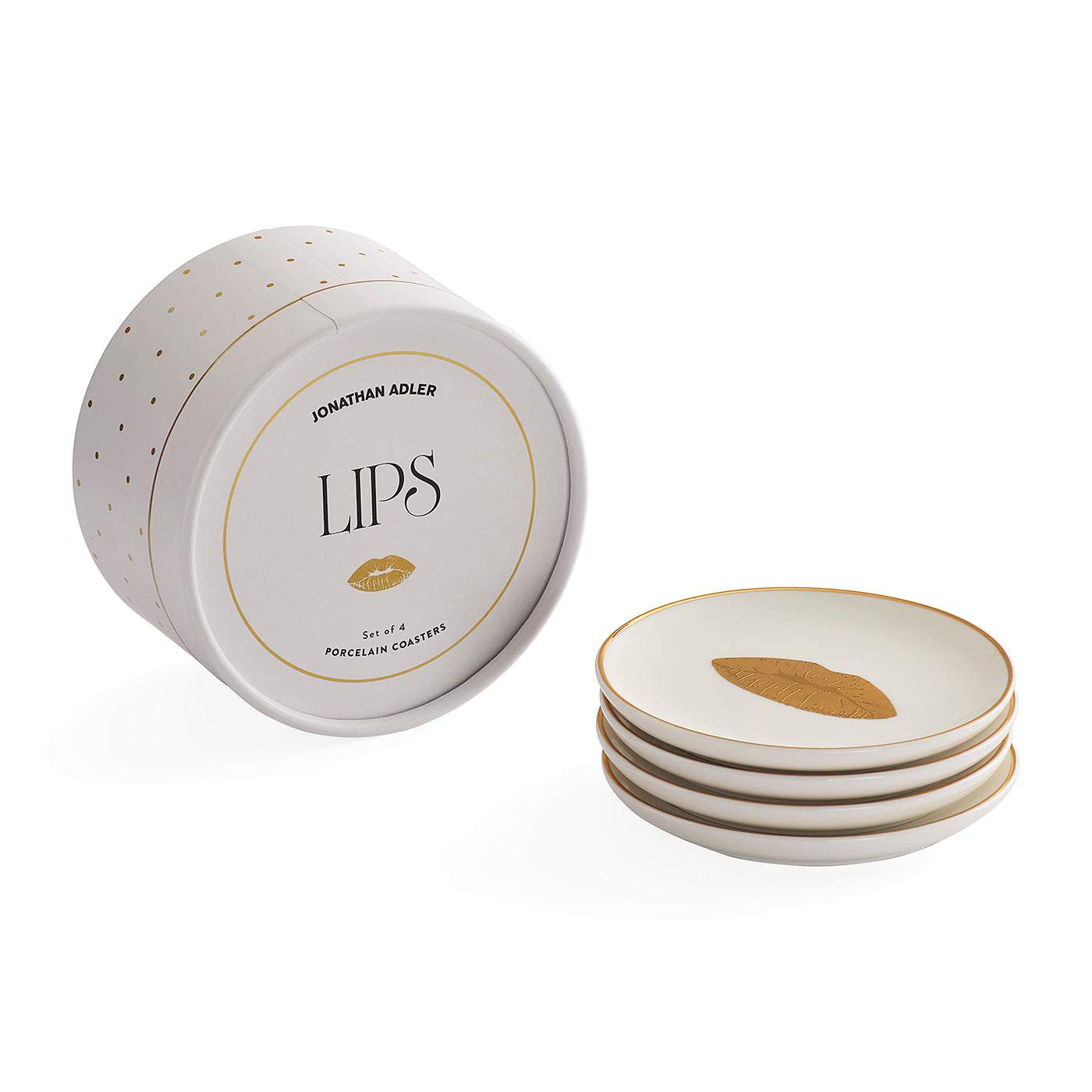 Jonathan Adler LIPS porcelain coasters, shown with the round branded storage container and a stack of four white coasters featuring gold rim detailing and a gold leaf motif.