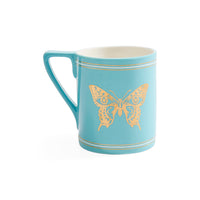A light blue ceramic mug with a gold butterfly design and thin gold stripes, shown on a plain white background.