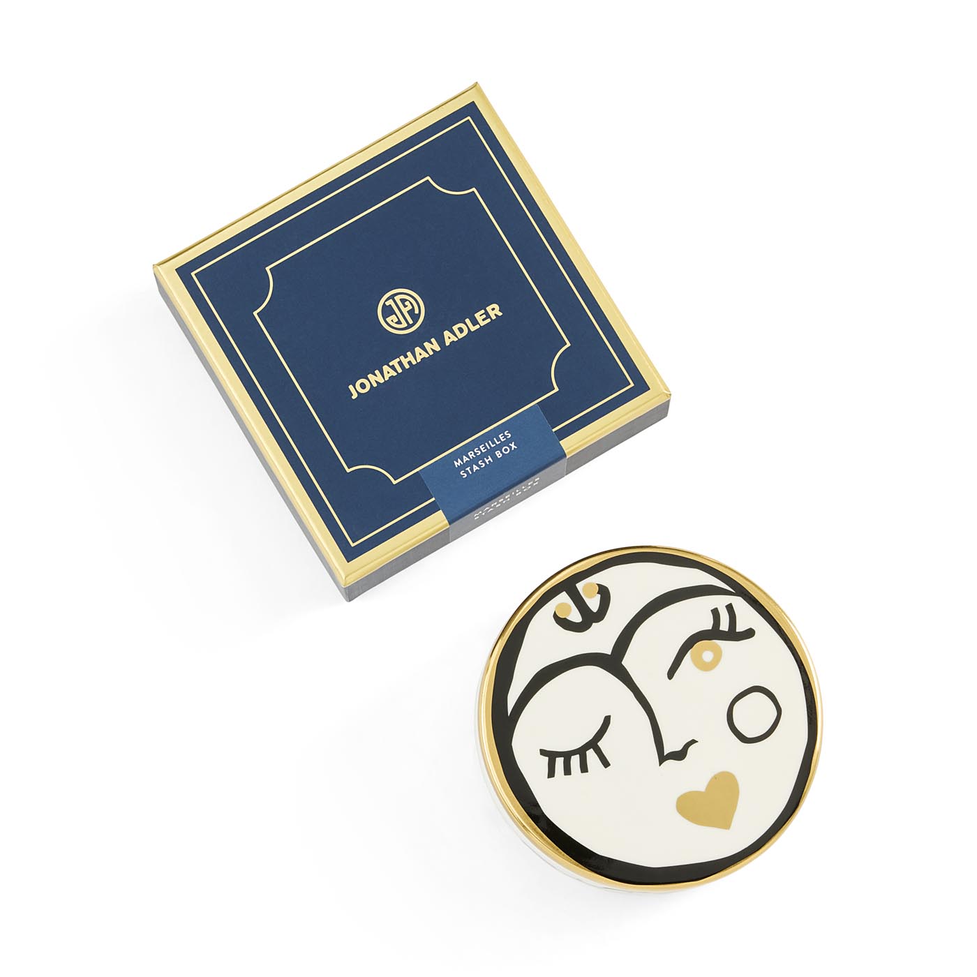 Decorative plate with artistic design and Jonathan Adler packaging on a white background