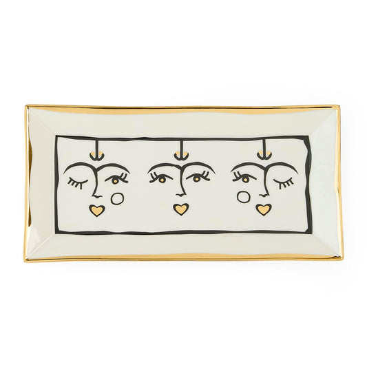Rectangular ceramic tray with abstract face design on a white background