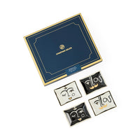 Set of decorative face-shaped trinket dishes with Jonathan Adler box on a white background