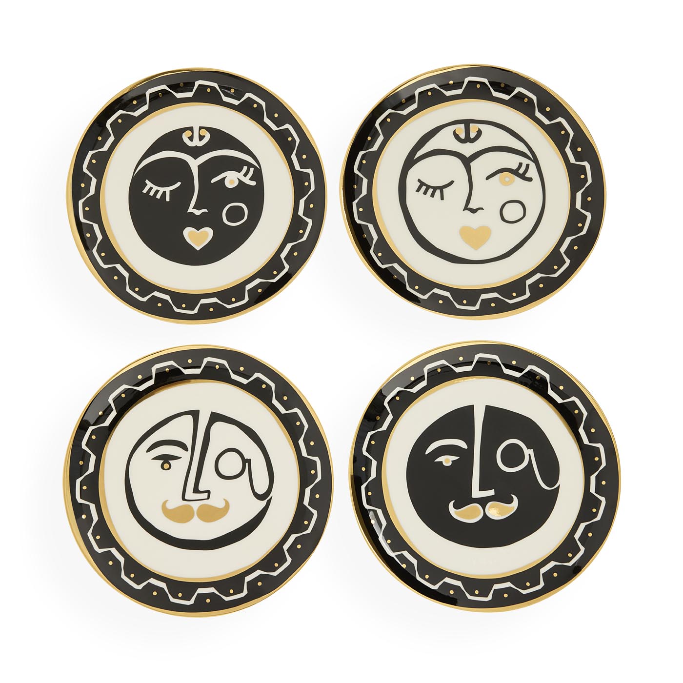 Four decorative plates with face designs on a white background