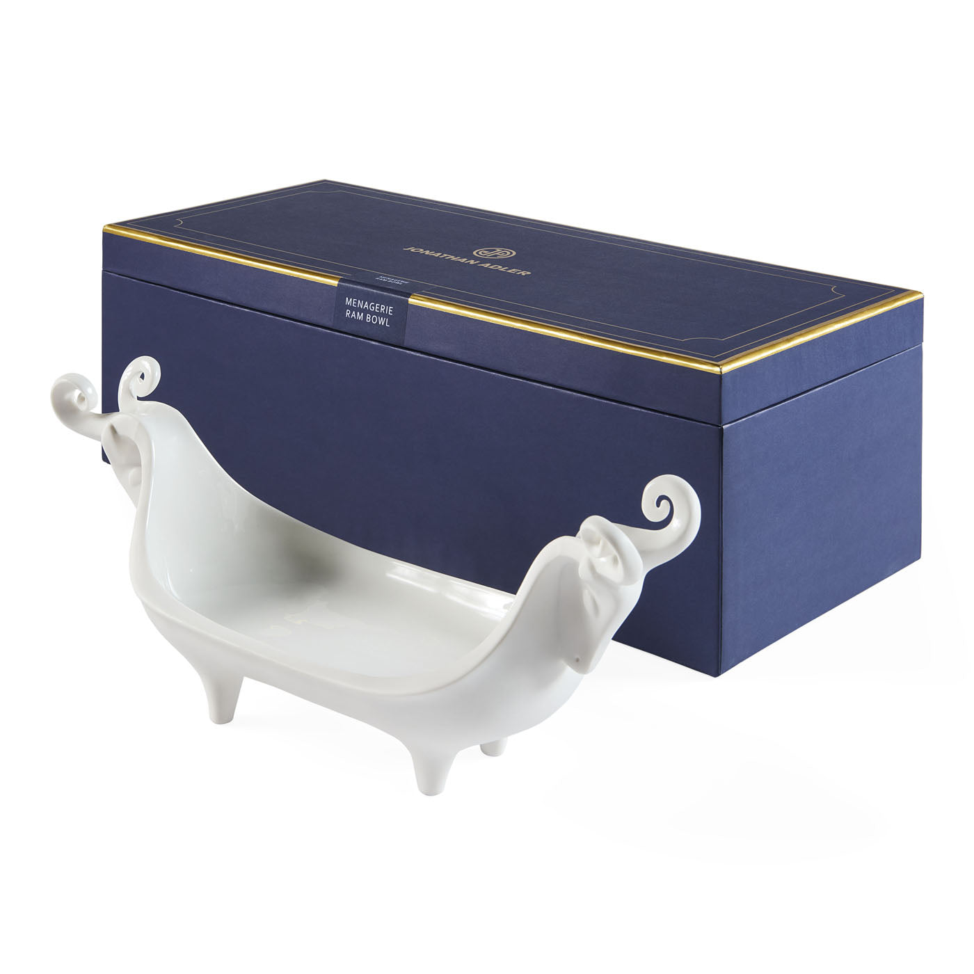 White decorative dish with curved handles in front of a blue box with gold accents