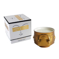 porcelain candle with gold exterior; two wick; face shaped  with box