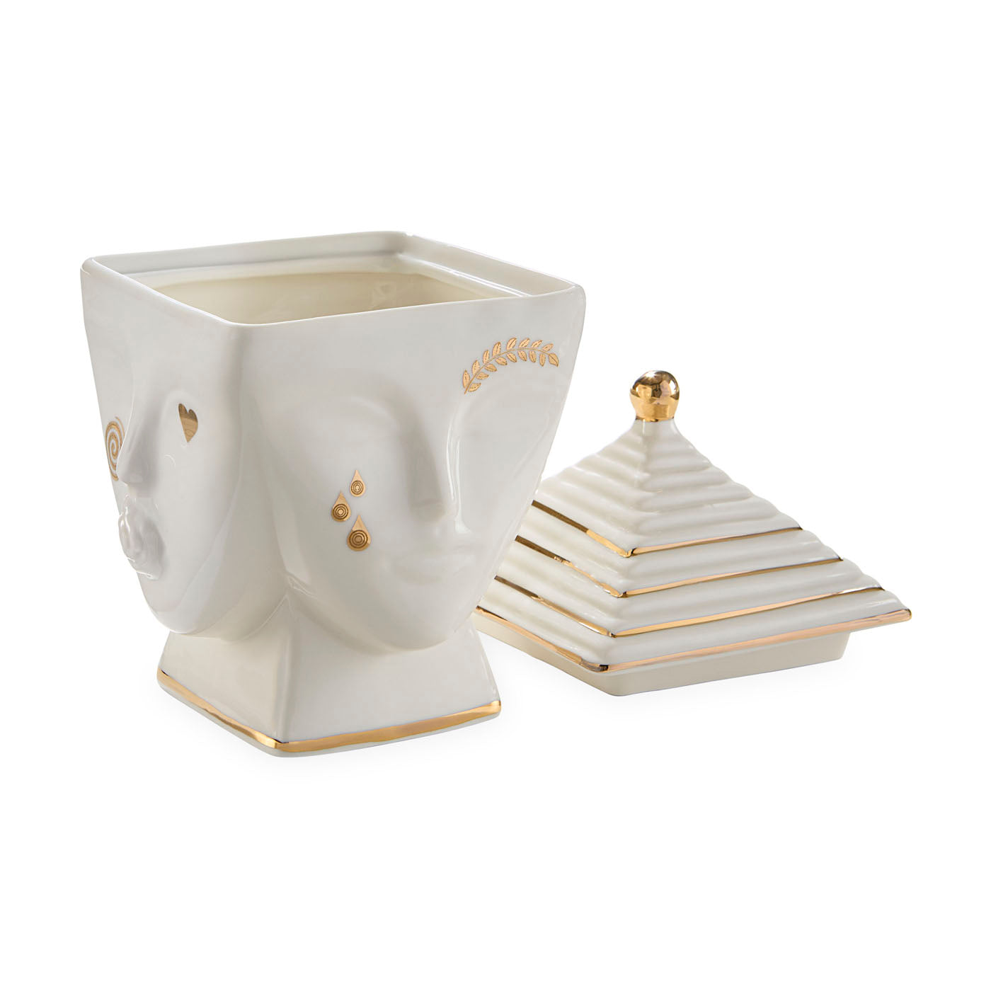 Decorative white container with gold accents resembling a face, on a white background